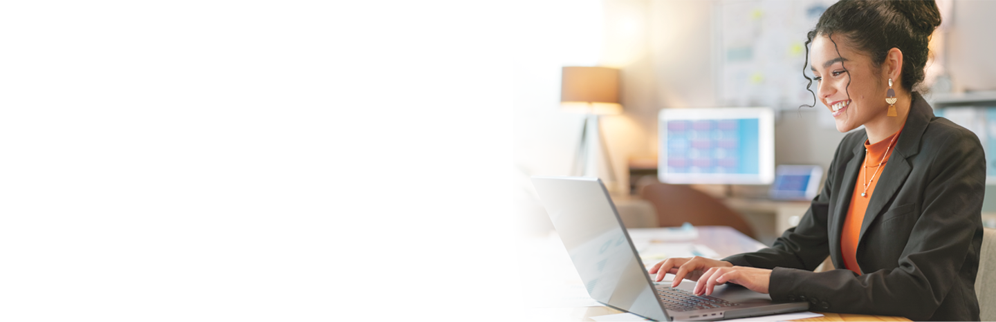 Young woman smiling while working on computer